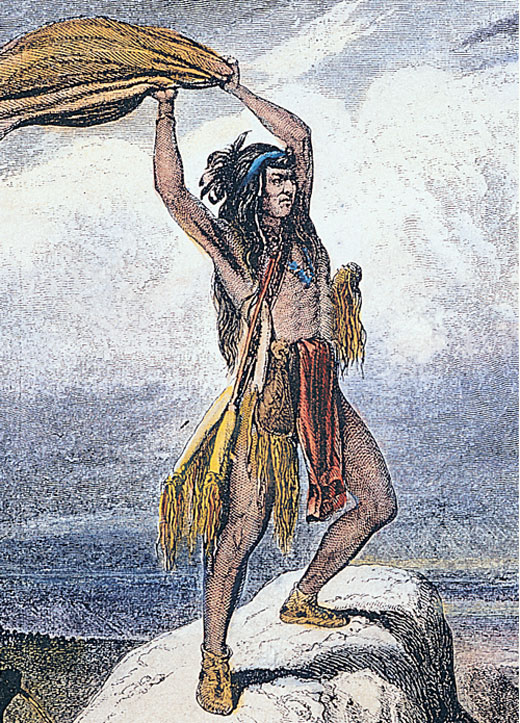 Native American holding a blanket over his head.