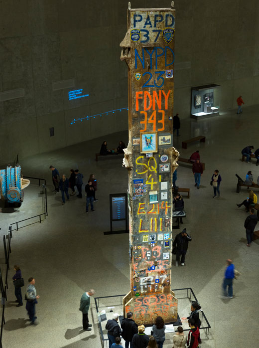 A rusted column inscribed with first responder tributes inside the 9 11 Memorial Museum.