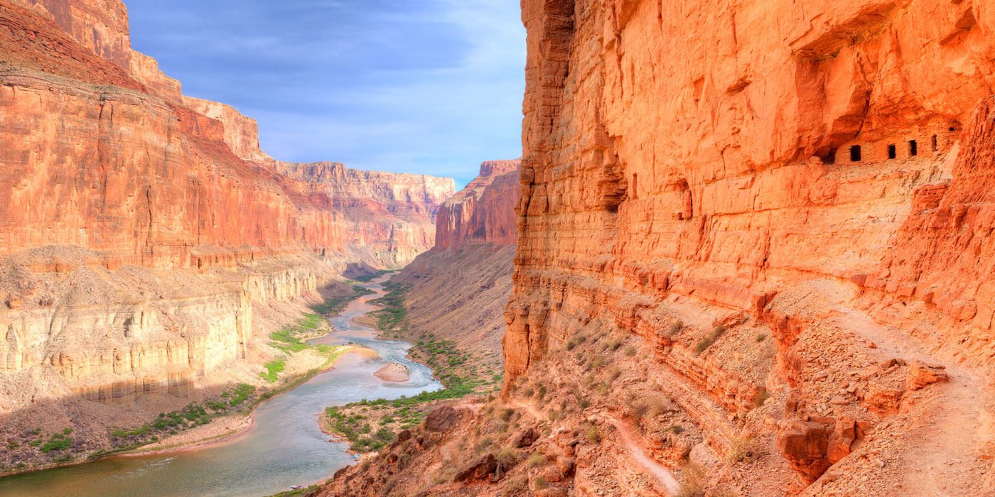 View through the Grand Canyon showing the rock faces on both sides and the river flowing through the middle.
