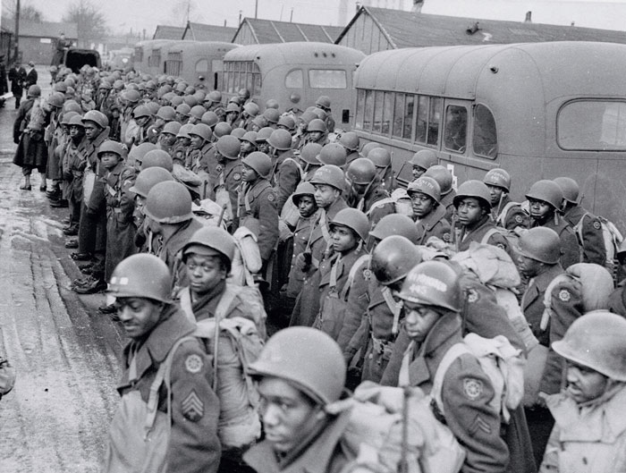Several African American soldiers wearing combat gear