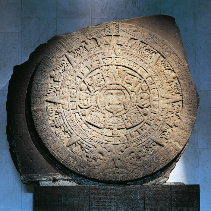 Large circular stone with engravings on it. 