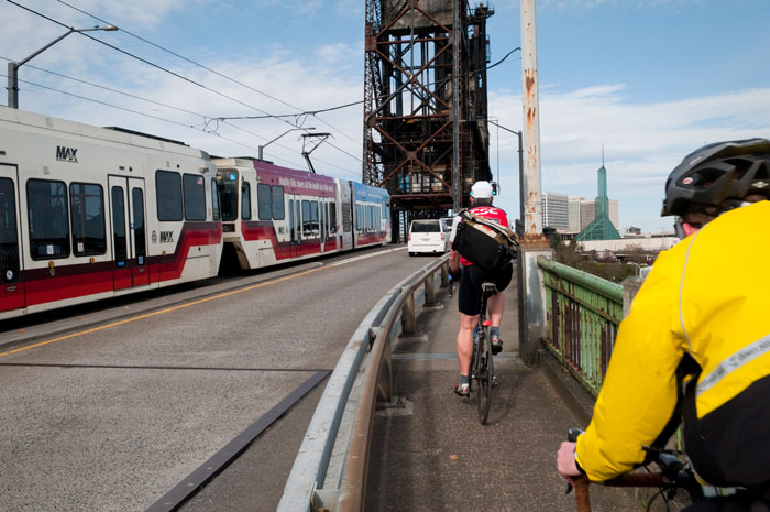 Bike lane running parallel to the train tracks and highway.