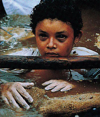 Small child trapped in mud.