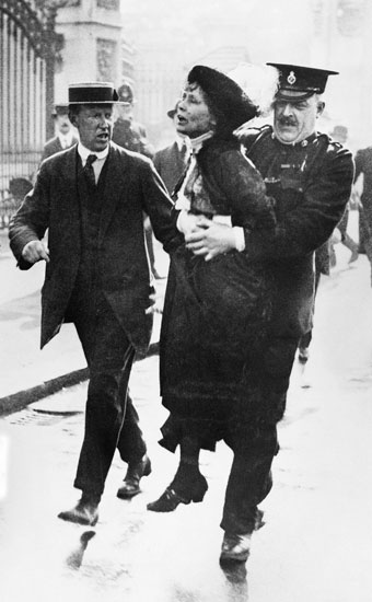 Photo of a woman being seized by a police officer.