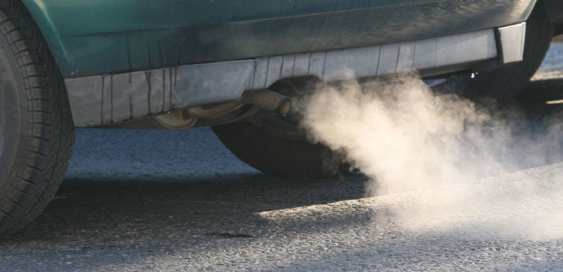 Exhaust coming out the tailpipe of a car.