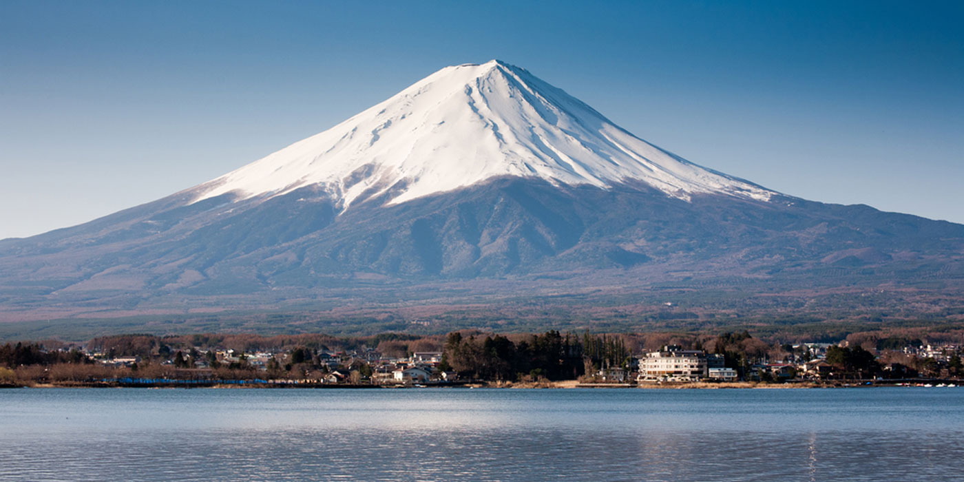 Mount Fuji with snow covering its peak and having a very wide base. 