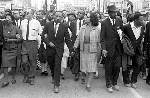 Martin Luther King Junior leading a crowd of people during a march to Selma Alabama.