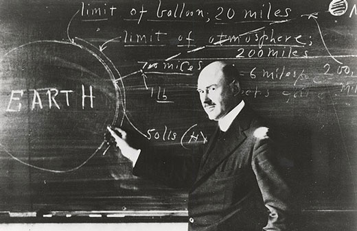 Robert Goddard in front of a chalkboard.