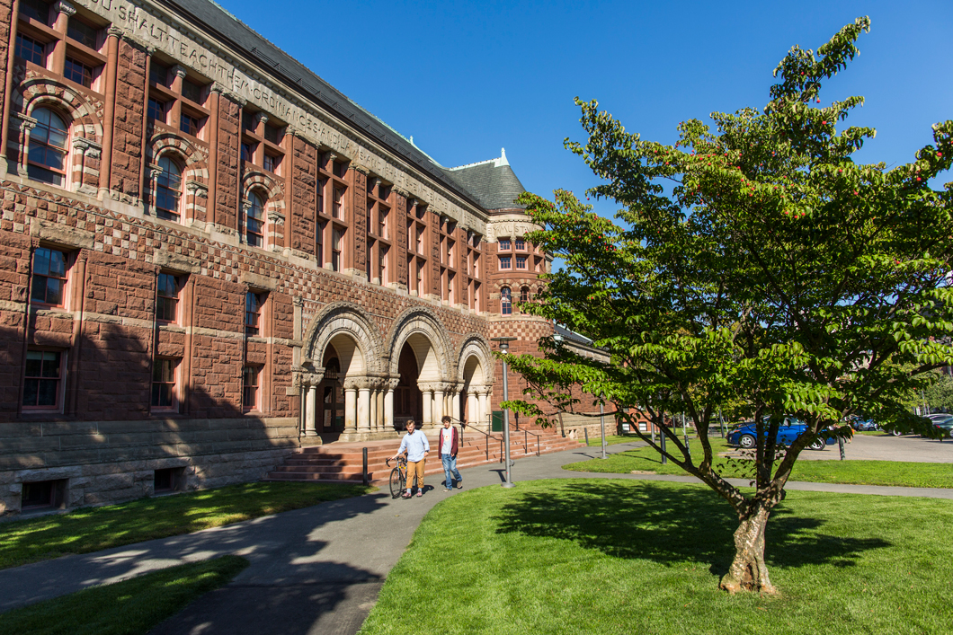 A brick building by walking paths.