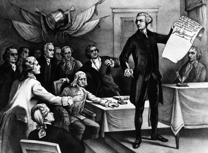 John Hancock holding the Declaration of Independence showing his signature to others in the Congress.