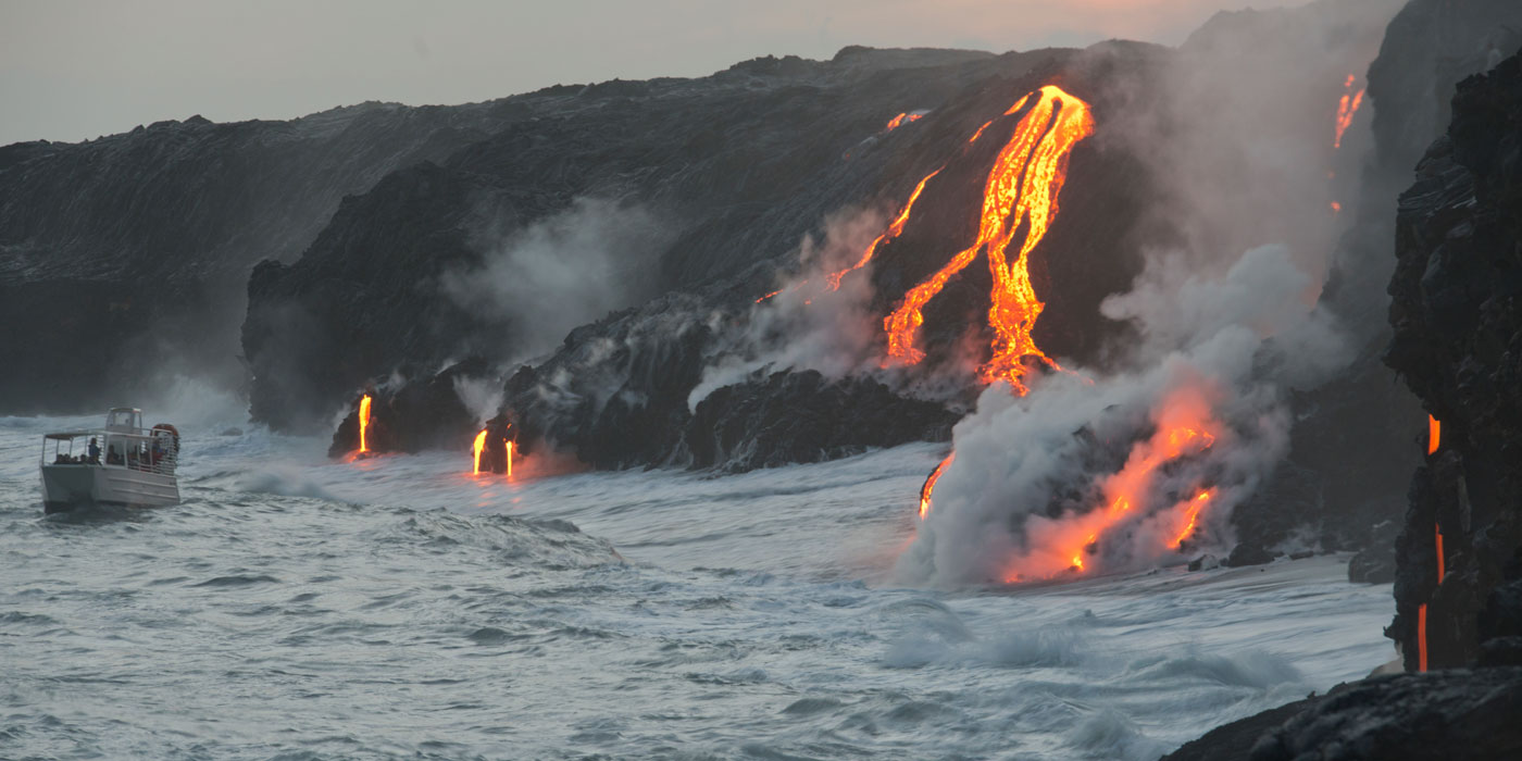 Lava from a volcano in Hawaii flows down the side of the volcano and into the ocean.