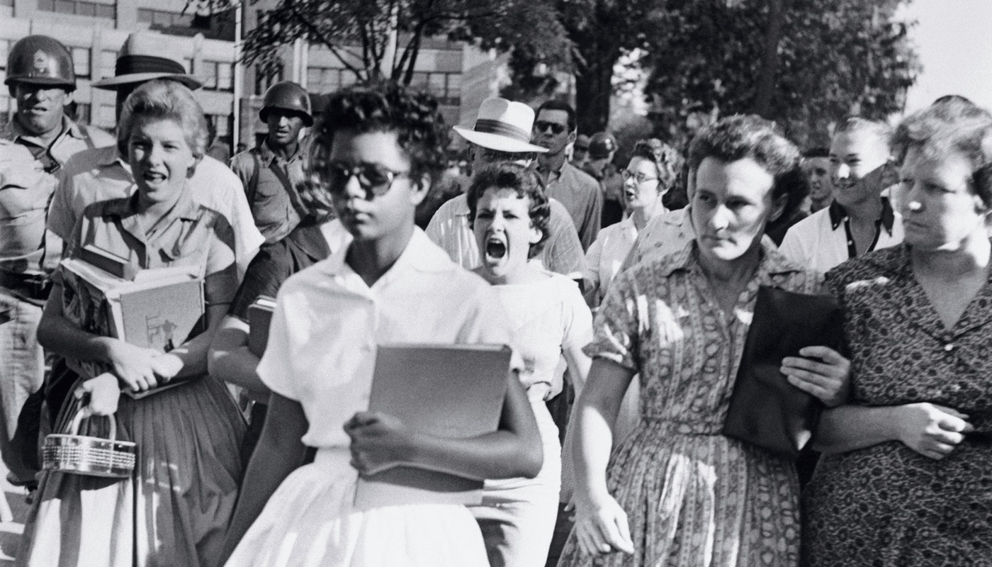 African American students walking towards Central High School in Arkansas while being yelled at by white students