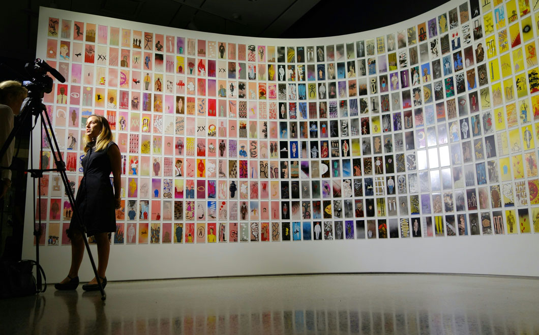 Manju Shandler standing in front of her artwork. 