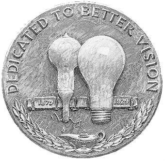 A coin with two light bulbs printed on it and the motto dedicated to a better vision. 