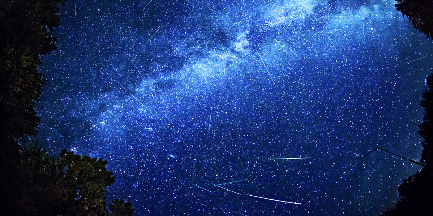 Field of stars and the trails left behind by comets moving through space.