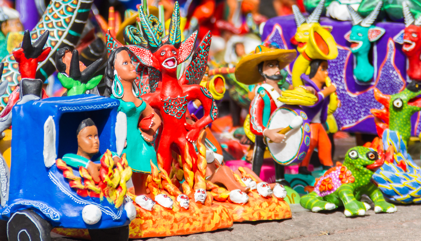 Colorful statues made of clay and in the shapes of demons, people, and frogs.