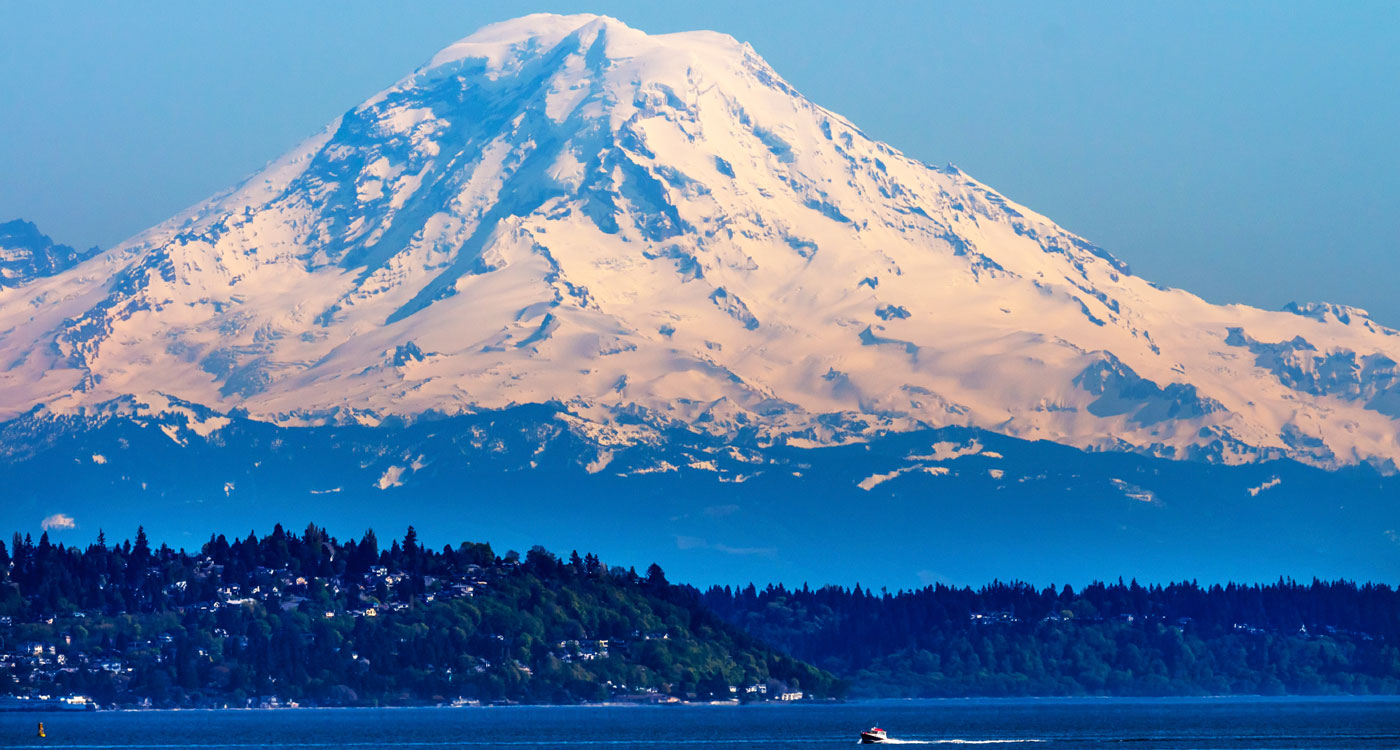 Volcano with snow covering most of its sides.