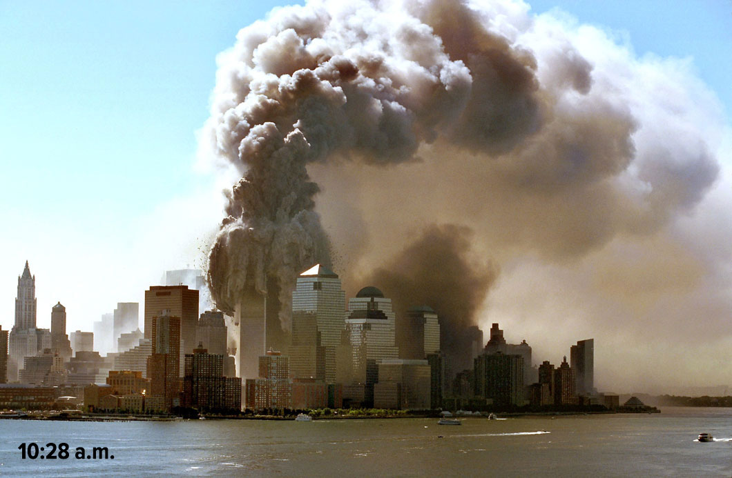 Massive smoke plume rising from the North Tower as it starts to collapse, with a time stamp of 10:28 a.m.