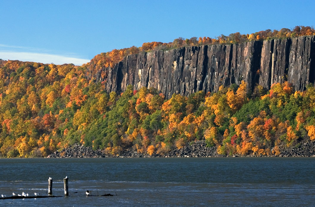Tall rocks emerge from the ground along the banks of a river in New Jersey.