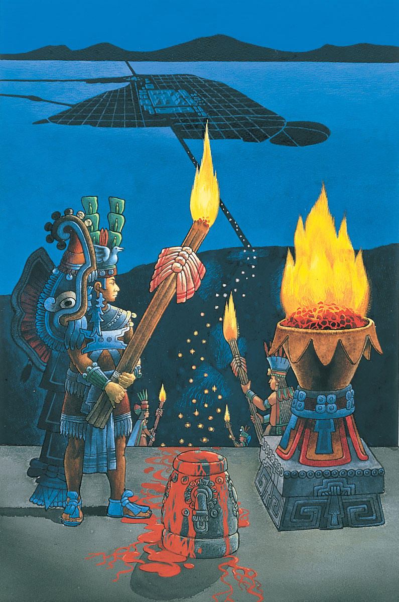 Man wearing a headress holding a long torch while standing in front of a large fire on top of a pyramid.