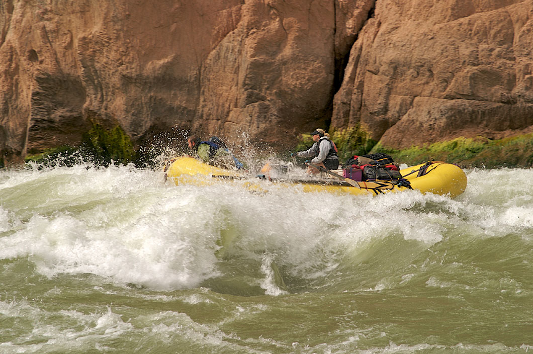 Person rafting down a violent river.