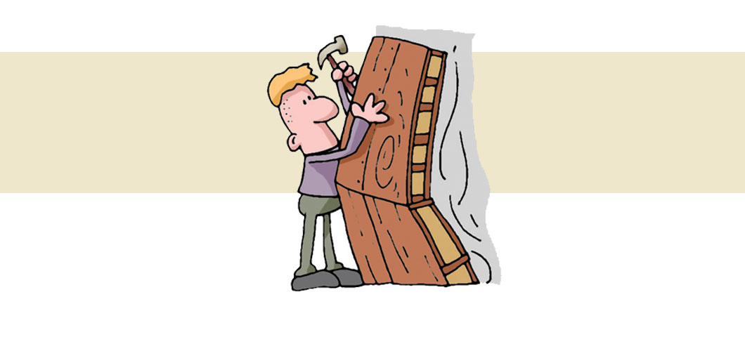 Cartoon of a workman hammering part of the wooden model together.