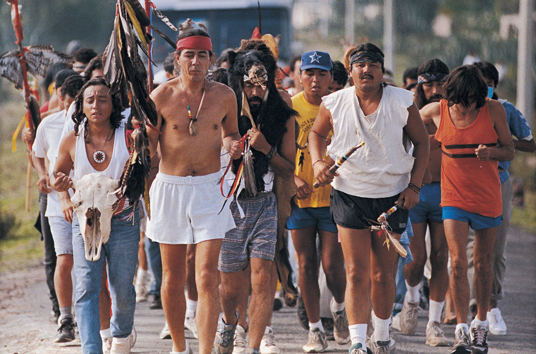 Many Native Americans participating in a road race.