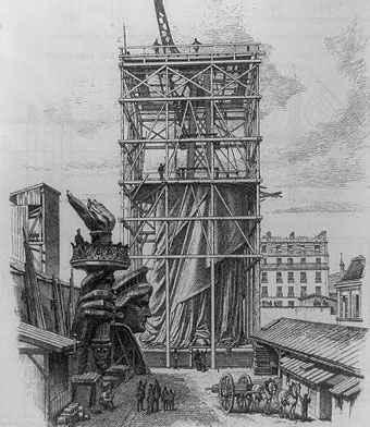 Illustration showing the iron skeleton being built inside a wooden frame around the statue.