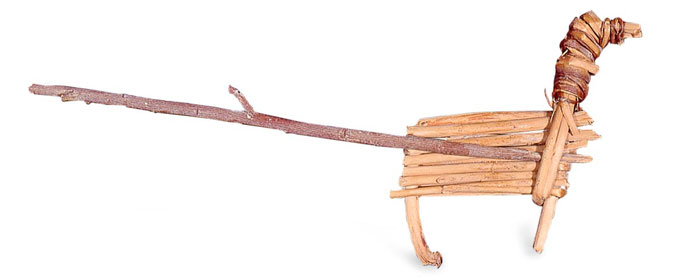 Doll made of strips of wood that have been formed into the shape of a bighorn sheep.