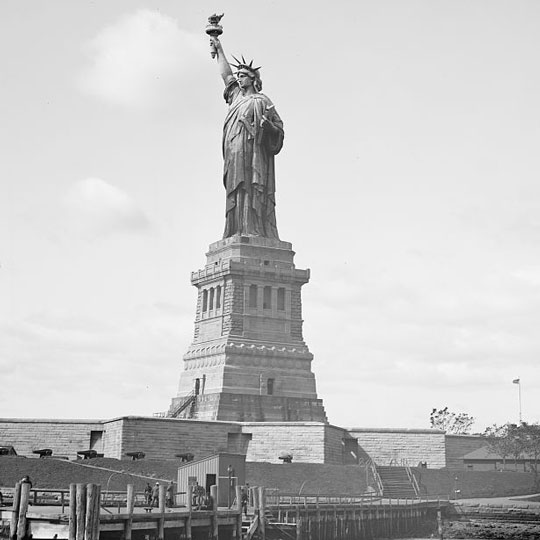 Photo of the Satue of Liberty standing on a base at Liberty Island.