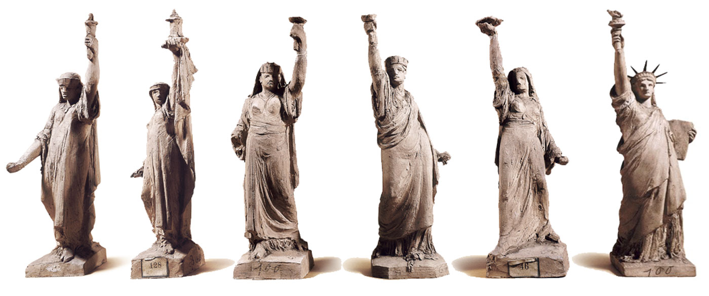 Six clay models of the Statue of Liberty.
