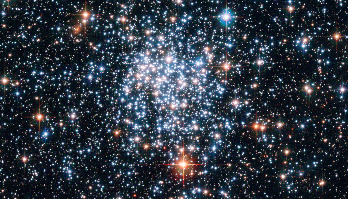 Large cluster of stars with other stars around it. 