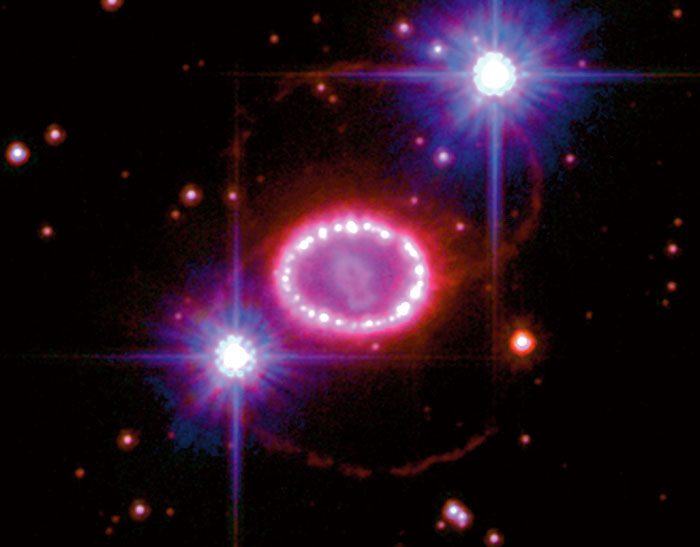 Very bright ring of gas is seen in the center of two bright circular stars.