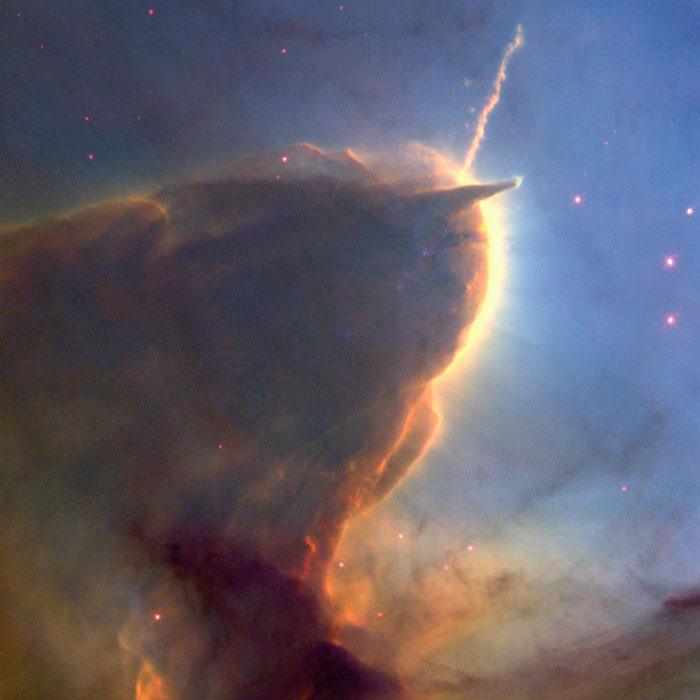 Large cloud of gas with two thin projections coming off of it that look like antennae.