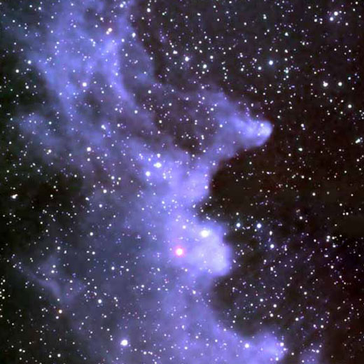 Cloud of gas with stars visible through it.