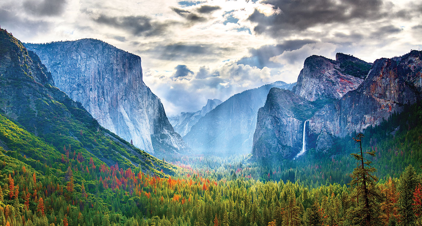 A mountain range, valley, and forests.