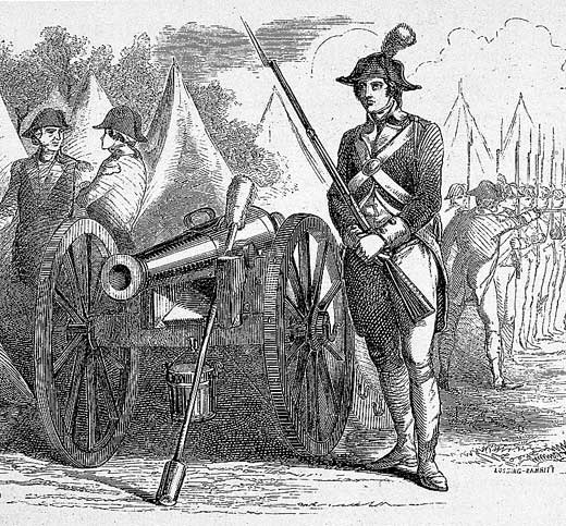 A soldier standing by a canon.