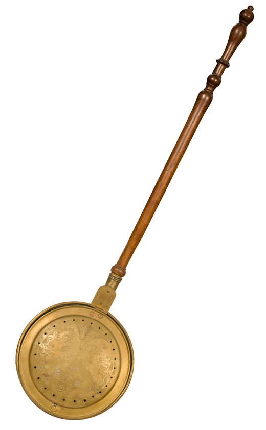 Pan with a long handle and a cover with holes in it. 
