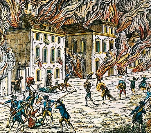 Several building on fire as people run in the streets. British soldiers are seen hitting a colonist. 
