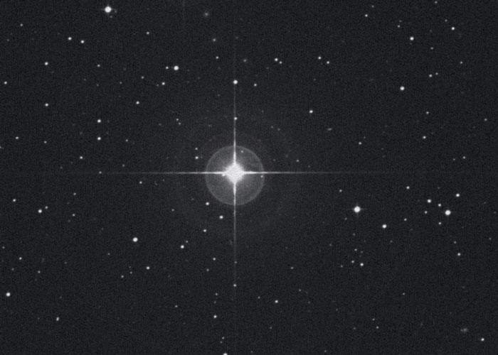 Image of a star in space that appears as a very bright dot in the center.