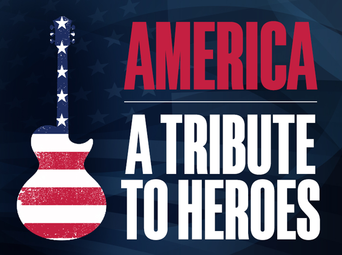 A sign that reads, America a tribute to heroes, alongside an American flag-themed guitar.